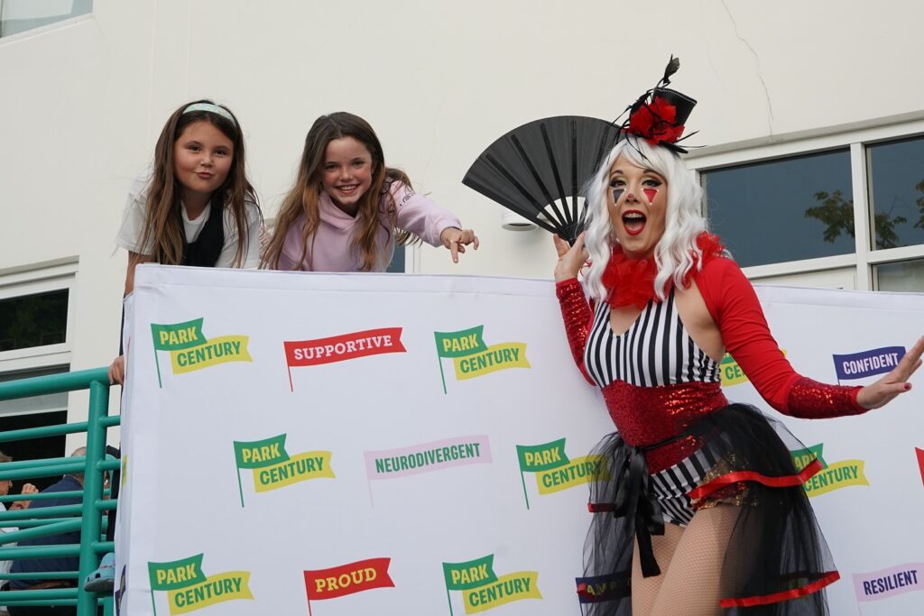 woman in costume playing with two young girls