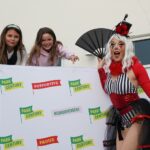 woman in costume playing with two young girls