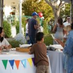 families checking out vendor tables at event