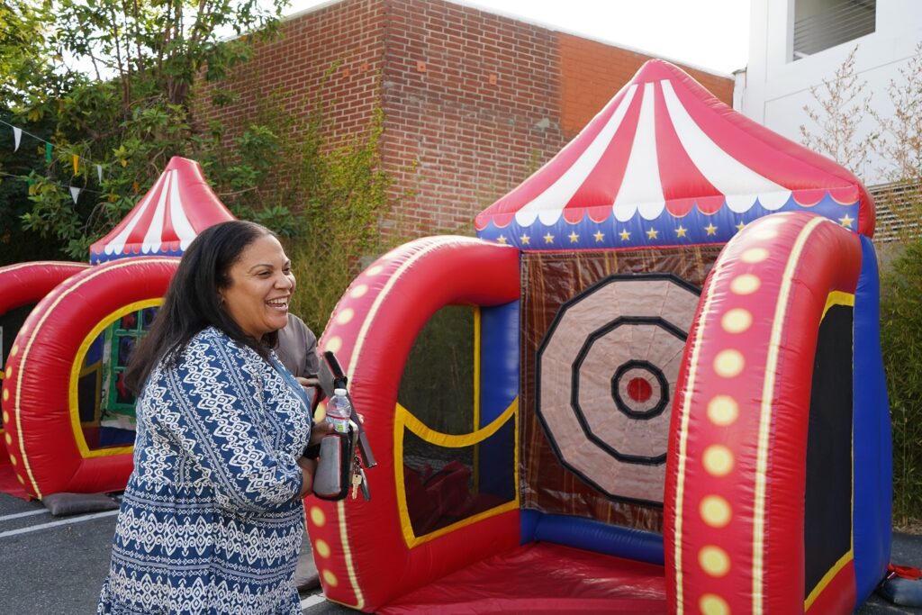 mom smiling outside a bounce house